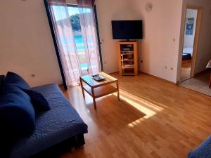 a living room with a couch and a table at Apartmani Grubiša in Drvenik