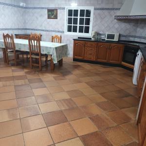 a kitchen with a table and chairs and a stove at Casa Rural MATEOS in El Puerto de Santa María