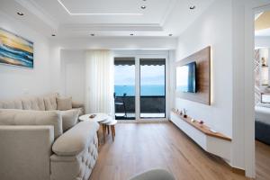 a living room with a couch and a bed at The Blue Pearl Apartment in Durrës