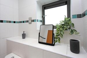 a mirror sitting on a counter in a bathroom at Albion Street Apartments in Wolverhampton +83 photos