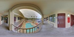 an empty building with a pool in the middle at Deluxe Inn and Suites in Raymondville