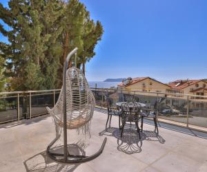a pair of chairs and a table on a balcony at Happy Kaş Apart in Kaş