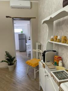 a kitchen with a stove top oven next to a table at Goti Rooms B&B in SantʼAgata deʼ Goti +33 photos