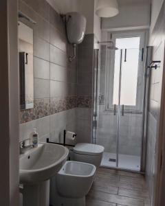a bathroom with a toilet and a sink and a shower at Le Cavallerizze in Caserta +14 photos