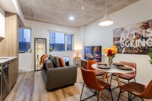 a living room with a table and chairs at Cute 1BDR Apt in Ste-Catherine - MTL Live Spot in Montréal +14 photos
