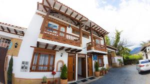 Casa con balcón en una calle en ApartaHotel Margaritas de la Villa VDL, en Villa de Leyva