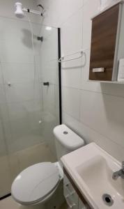 a bathroom with a toilet and a shower and a sink at Brisa mar pousada in Ubatuba