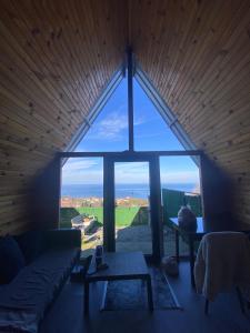a large window in a room with a couch and a table at Amasra Miray Deniz Bungalow in Amasra