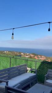 a bench on a balcony with a view of the ocean at Amasra Miray Deniz Bungalow in Amasra +1 photo