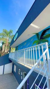 a blue building with a clock on the side of it at Brisa mar pousada in Ubatuba