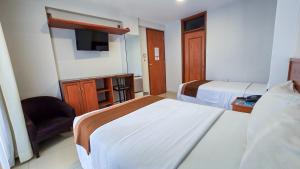 Postel nebo postele na pokoji v ubytování Retama Hotel Tacna