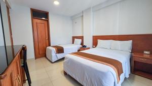 Postel nebo postele na pokoji v ubytování Retama Hotel Tacna