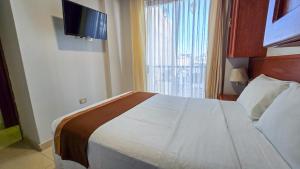 Postel nebo postele na pokoji v ubytování Retama Hotel Tacna
