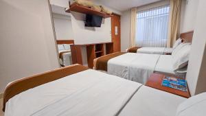 Postel nebo postele na pokoji v ubytování Retama Hotel Tacna