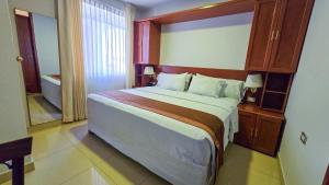 Postel nebo postele na pokoji v ubytování Retama Hotel Tacna