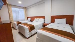Postel nebo postele na pokoji v ubytování Retama Hotel Tacna