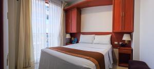 Postel nebo postele na pokoji v ubytování Retama Hotel Tacna