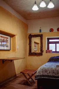 a bedroom with a bed and a mirror on the wall at Casa Rustica Ixtlán in Ixtlán de Juárez