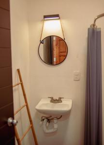 a bathroom with a sink and a mirror at Casa Rustica Ixtlán in Ixtlán de Juárez