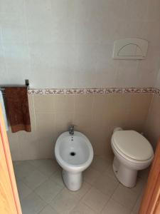 a bathroom with a toilet and a bidet at South Italy summer house in Stazione di San Sostene +16 photos