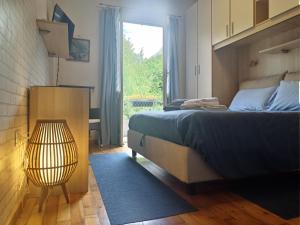Postel nebo postele na pokoji v ubytování Valtellina-La casetta di Elena
