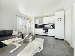 a living room with a couch and a table at The gateway to Senja in Senja