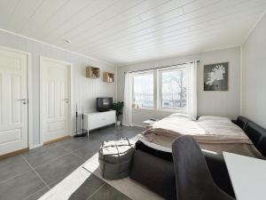 a bedroom with a bed and a table and a television at The gateway to Senja in Senja