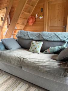 a couch with pillows on it in a room at Small cottage in Contamine-sur-Arve
