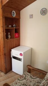 a small white refrigerator in a corner of a room at The Rock View in Petra