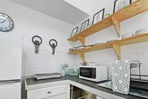 a kitchen with a counter top with a microwave at Anastasia Island Treehouse in St. Augustine +33 photos