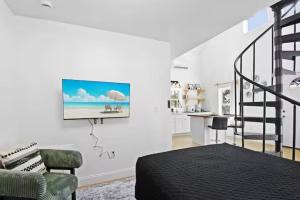 a bedroom with a bed and a tv on the wall at Anastasia Island Treehouse in St. Augustine