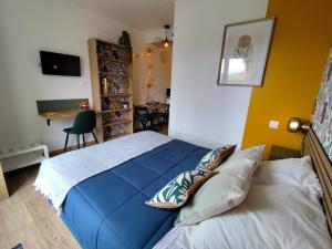 a bedroom with a blue bed and a desk at Dousserença in Bressols