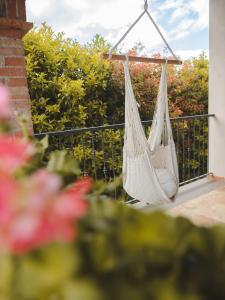 a white hammock hanging on a balcony at Agriturismo Camponovo in Brisighella
