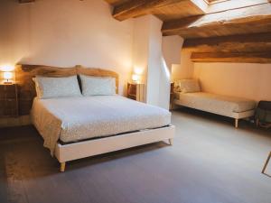 a bedroom with a bed in a room with wooden ceilings at Agriturismo Camponovo in Brisighella