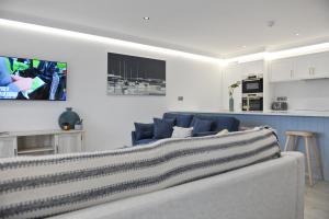 a living room with a couch and a kitchen at The Pier Portrush in Portrush