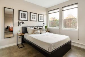 a bedroom with a large bed and two windows at Bright Studio Apartment - Food Carts & Local Shops in Portland +20 photos