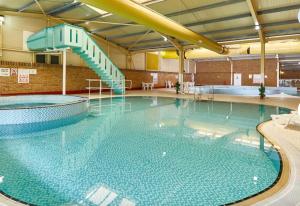 a large swimming pool with a slide in it at Willow Way 256 in Camber