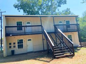a building with a spiral staircase in front of it at SFA Retreat, Spacious Downtown Apartment in Nacogdoches