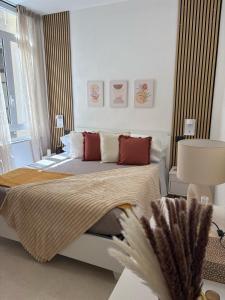 a bedroom with a large bed with red pillows at Ti porto al mare - Luxury & Relax in Siracusa
