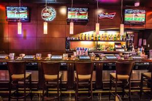 a bar with chairs and televisions in a room at Century Casino & Hotel Cripple Creek in Cripple Creek