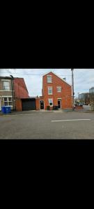 a large red brick building next to a street at Room 1 in south Yorkshire in Sheffield