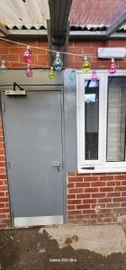 a white garage door with christmas lights on it at Room 1 in south Yorkshire in Sheffield +2 photos