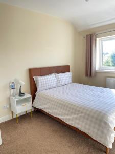 a bedroom with a bed and a window at Spacious 3 bed with driveway in Manchester