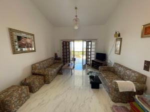 a living room with two couches and a tv at North coast Great nightlife shoreside Marina AlAlamain مارينا الساحل الشمالي in El Alamein