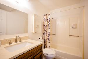 a white bathroom with a sink and a toilet at 2 bedroom UNLV, Thomas Mack in Las Vegas