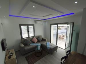 a living room with a couch and a table at Résidence Inès Djerba Appartements VIP in Houmt Souk