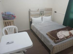 a bedroom with a bed and a table and a white desk at Gite ritch in Rich
