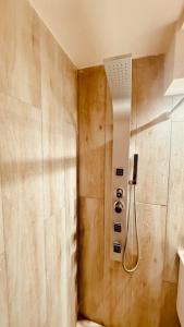 a shower in a bathroom with a shower head at Departamento a Orilla del Lago in San Carlos de Bariloche