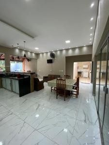 eine große Küche und ein Esszimmer mit Tisch und Stühlen in der Unterkunft Casa Colorado Thermas Laranjais Olimpia in Olímpia + 43 Fotos