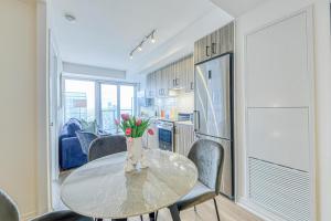 a kitchen and dining room with a table and chairs at RivetStays - The Jarvis in Toronto